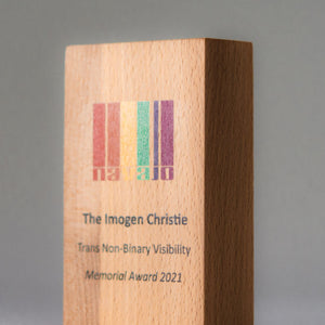 Wooden award with engraved text on a gray background